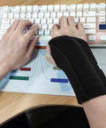 Person typing on keyboard wearing Wrist Brace For Carpal Tunnel Relief Right Or Left Hand With Night Wrist Sleep Support Adjustable Straps