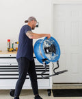 Person carrying a Powerful 18-Inch High-Velocity Heavy-Duty Industrial-Grade Floor Fan with 3 Speeds and 3-Position Tilt for Reliable Cooling