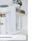 Zero Drama Instant Boiling Water Dispenser And Rapid Chill Formula Preparation Machine with a white bottle being placed.