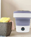 Hella Efficient Compact Foldable Mini Washer With Slick Drainage Setup And Pure Copper Motor Plus Gentle Handwash Simulation For Delicates And Baby Clothes Green Finish in a laundry room setting.