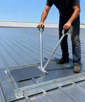 Standing Seam Roofing Hand Seamer for 0.8 to 1 millimeter metal panels in use on a metal roof with 24 inch handle and 6 lb weight.