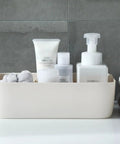 Stackable Plastic Underwear Storage Containers With Divided Compartments To Straighten Up Your Wardrobe Kick Clutter To The Curb Keeping Socks Bras Neck Ties Squeaky Fresh with toiletries in a beige container.
