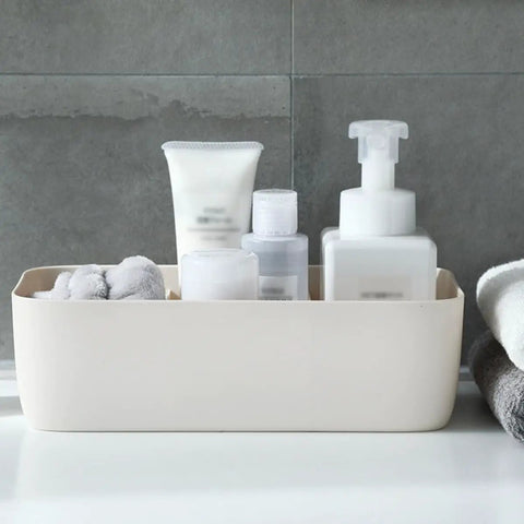 Stackable Plastic Underwear Storage Containers With Divided Compartments To Straighten Up Your Wardrobe Kick Clutter To The Curb Keeping Socks Bras Neck Ties Squeaky Fresh with toiletries in a beige container.