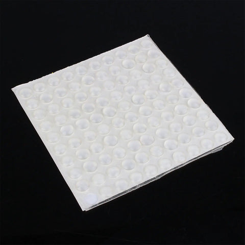Sheet of 2 Inch Drawer Bumpers Set With Self Adhesive Silicone Feet For Quiet Cabinets And Drawers on black background.