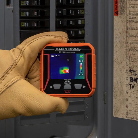 TI250 Rechargeable Thermal Imaging Camera With 19,200 Pixel Resolution And Three Color Palettes held by a gloved hand for electrical panel inspection