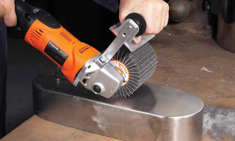 CoolCut Linear Finishing Flap Abrasive Drum 40 Grit 4 And A Quarter Inch in use on metal surface by worker.