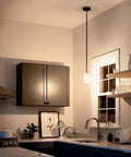 Industrial kitchen with a Braelyn 8.5 Inch One Light Mini Pendant With Clear Seeded Glass And Classic Pewter Finish above sink area.