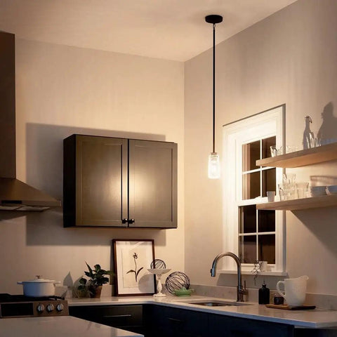 Industrial kitchen with a Braelyn 8.5 Inch One Light Mini Pendant With Clear Seeded Glass And Classic Pewter Finish above sink area.