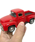 Hand holding Red Metal Truck Christmas Decor For Farmhouse Style Vintage Pickup Truck Tabletop Storage Die Cast Metal With Hand Painted Finish Perfect Holiday Gift For Car Folks And Decor Enthusiasts.