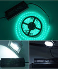 Beefy 120W 12V DC LED Power Supply With IP67 Waterproof Rating, shown powering green 12V LED strip, floodlight, and spotlight.