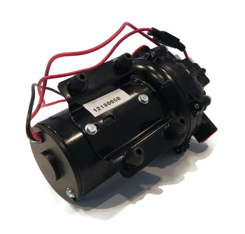 Rock Solid 12 Volt Diaphragm Pump Cracking Out Four Gpm For Zero Sweat Fluid Moving And Crop Spraying With Self Priming Capability Hooked To One Half Inch Npt Ports Pushing Sixty Psi Pressure close-up view of diaphragm pump with wires and ports