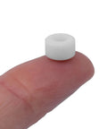 Apex 71D Urethane Fingerboard Wheels With Ultra Spin Bearings, 7.7mm diameter, shown on fingertip for scale, white color.