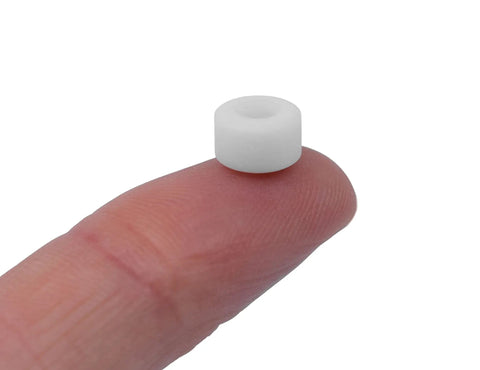 Apex 71D Urethane Fingerboard Wheels With Ultra Spin Bearings, 7.7mm diameter, shown on fingertip for scale, white color.