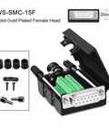 Front view: DB15 15-pin D-sub connector, green terminal blocks in black housing; rubber sleeves and screws.