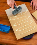 Person using Go-To 5 Inch Wood Glue Roller With Thermoplastic Rubber Roller Silicone Rest And ABS Handle Detachable Glue Applicator on board