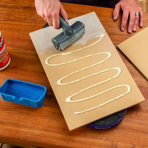 Person using Go-To 5 Inch Wood Glue Roller With Thermoplastic Rubber Roller Silicone Rest And ABS Handle Detachable Glue Applicator on board