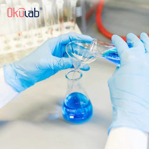Hands pouring liquid into Sturdy Borosilicate 3 3 Glass Conical Flask Set With Printed Graduation 50 Milliliters Each Six Pack Great For Lab Experiments Tough As Nails Built Heat And Chemical Resistant
