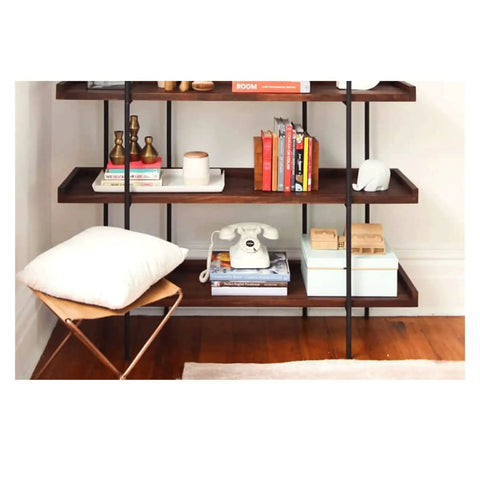 Built Different Heavy Duty Black Iron Bookshelf With Real Wood Shelves Industrial Floor Standing Storage Rack For Living Room Setup Home Office Display Organizer showcasing books, decor, and a phone on shelves.