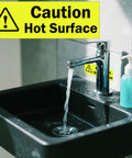 Large Hot Surface Warning Stickers Pack Ten Self Adhesive Vinyl Signs Keep Hands Off For Machinery Engines Exhaust Pipes And Kitchen Equipment Easy Peel Safety Labels To Warn People About Temperature Danger shown on a sink.