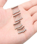 Dope 24 Piece Labret Barbell Set For Lip Helix Tragus And Cartilage Piercings In Surgical Steel Hypoallergenic 20G Includes 6Mm 8Mm 10Mm And 12Mm Sizes With Velvet Gift Bag Great Gift For Women And Men. 24 surgical steel labret barbells in assorted lengths on a hand