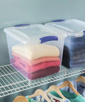 Heavy-Duty Clear Plastic Storage Bins With No-Fuss Blue Latches, 27 Qt Stackable Organizers For Wardrobe Clothes And Bulk Supplies, Bpa Free And Built Tough To Handle Heavy Lifting, 2 Pack with stacked sweaters in a closet.