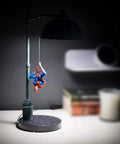Spider Man Streetlight LED Mood Desk Lamp For Heroes Night Light 16 Inch Marvel Themed Desk Light With Bright LED Glow Lit Street Lamp Style For Fans And Collectors on a desk with Spider-Man figure hanging.