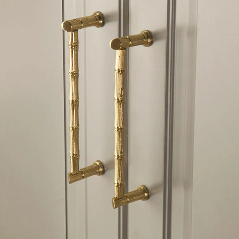 Gold Brass Bamboo Shape Cabinet Handles Set, Antique Brushed Copper Finish, installed on a cabinet with screw details visible