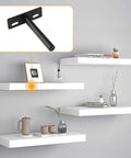 Rock Solid Four Inch Floating Shelf Brackets Set Of Four In Matte Black Featuring Invisible Mounting And Straight Up Easy Wall Install With Heavy Duty Industrial Steel on a wall with white floating shelves.