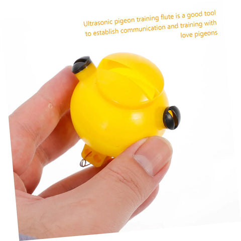 Hand holding yellow whistle from Two Pack Portable Three Tone Pigeon Training Whistles For Communication And Outdoor Loft Training Bird Supplies Compact 2.16 By 2.16 By 1.77 Inches Great For Loft Runouts And Field Sessions.