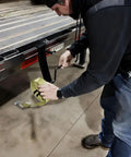 Person using Strap Winder For Flatbed Trailer Black Powder Coated Steel Cargo Tie Down Ratchet Strap Winder Winch Roller