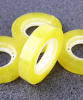 Close-up of Dope 12 Pack 11mm X 30m BOPP packing tape rolls, transparent with strong adhesive, ideal for packaging and school use.
