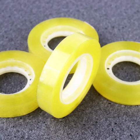 Close-up of Dope 12 Pack 11mm X 30m BOPP packing tape rolls, transparent with strong adhesive, ideal for packaging and school use.