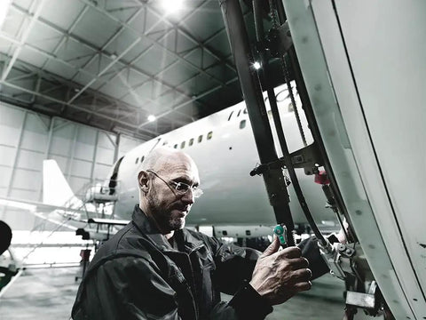 Man using 1/4 Inch Multi Tool Ratchet with Ball Lock, 90 Degree Release in aircraft maintenance hangar