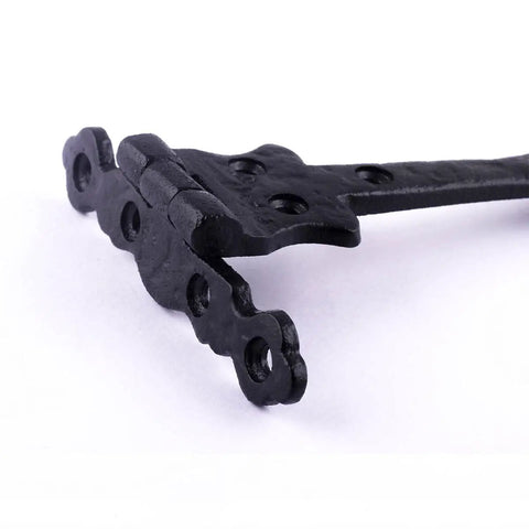 Close-up of Black Wrought Iron Door Strap Hinges, 6 Inch Long, Antique Colonial Spear Tip with visible holes and texture