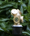 Close-up of Workhorse High Pressure Brass Sprayer Nozzle Set With Four Interchangeable Tips For Garden Irrigation against green foliage.