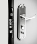Close-up of lock mechanism on Built Tough Steel Security Door With Frame And Hardware White 6 Panel Right Hand Hinged Outward.