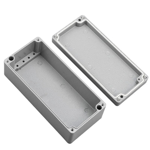 Junction boxes: two gray cast-aluminum IP66 waterproof enclosures with removable lids for outdoor electrical use.