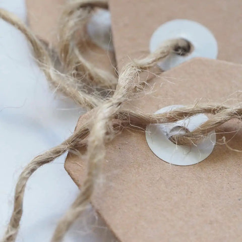 Close-up of 1000 Ft 3Mm Natural Jute Twine Rope Heavy Duty Garden String tied on brown paper tags