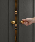 Hand opening door with Brushed Satin Gold Wide Base Bifold Closet Door Knobs 4 Pack With Golden Round Cabinet Wardrobe Drawer Pull Knobs Dresser One And A Half Inch Brass Handles Easy Install.