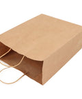 Kraft Paper Shopping Bags With Handles 50 Pack Reusable And Durable All Purpose For Grocery Runs Gifts Wrapping DIY Decor And Crafts Large Capacity 330x260x120 Mm laying flat on its side, showing sturdy construction and handle design.
