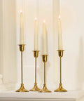 Flameless Taper Candles Set With Realistic 3D Wick Flame, 7 Inch Ivory Wax, 4 Pack displayed on gold holders
