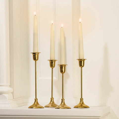 Flameless Taper Candles Set With Realistic 3D Wick Flame, 7 Inch Ivory Wax, 4 Pack displayed on gold holders