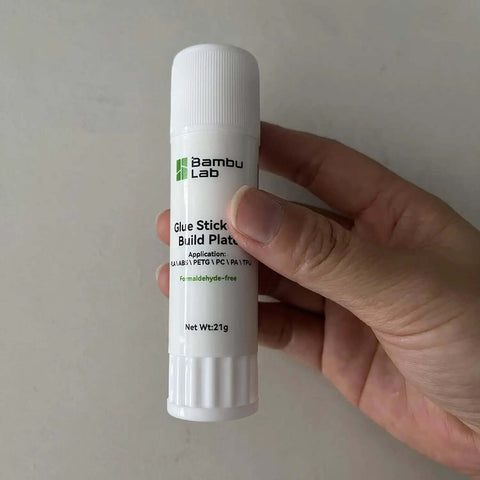 Hand holding a hot bed glue stick for 3D printing, suitable for A1 Mini P1 X1 printers with strong bed adhesion and easy release.