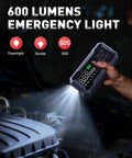 Person using Turbo Boost Eight In One Car Jump Starter with 600 lumens LED light on car engine at night