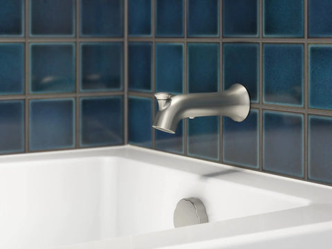 Simplice Rite-Temp Bath And Shower Trim Set with brushed nickel diverter bath spout and white bathtub against blue tile wall.