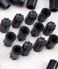Close-up of 50 Piece Black 6mm D Shaft Potentiometer And Encoder Knobs With Concave Rotary Design on a textured surface