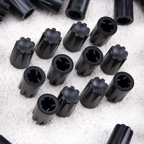 Close-up of 50 Piece Black 6mm D Shaft Potentiometer And Encoder Knobs With Concave Rotary Design on a textured surface
