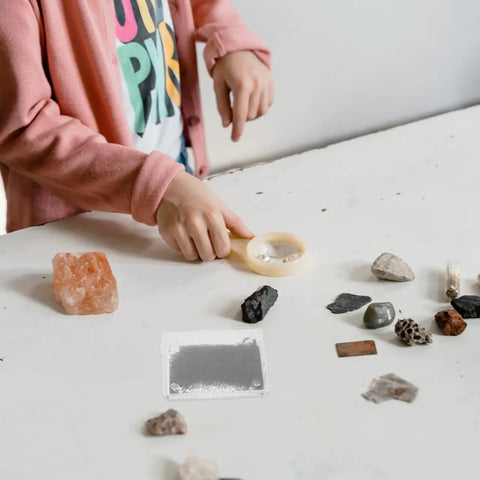 Child using 5 Piece Magnetic Field Demonstrator Kit With Iron Filings For Physics Classrooms Hands On Adjustable Magnetic Field Box