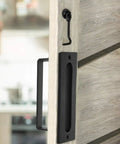 Go To Barn Door Handles Matte Black Easy To Install Heavy Duty Flush Pull And Lock Latch Built From Solid Steel With Powder Coat Finish Anti Rust Durable Hardware Included For Quick Mount On Most Barn Doors shown on a sliding wooden door.
