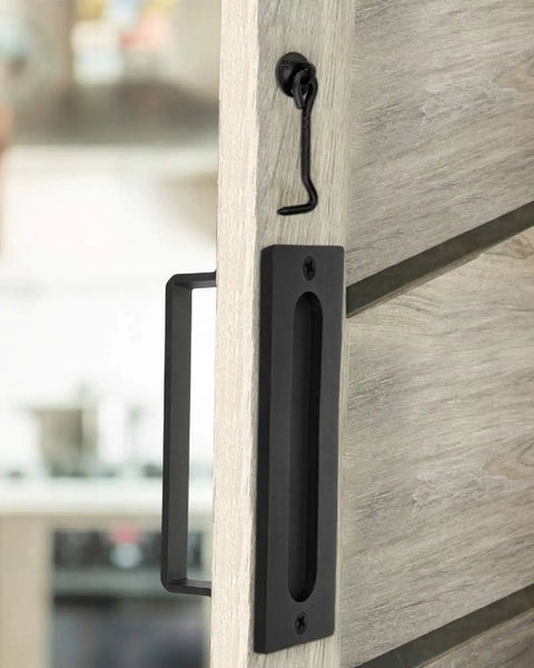 Go To Barn Door Handles Matte Black Easy To Install Heavy Duty Flush Pull And Lock Latch Built From Solid Steel With Powder Coat Finish Anti Rust Durable Hardware Included For Quick Mount On Most Barn Doors shown on a sliding wooden door.